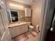 Bathroom features a vanity with sink, toilet, and neutral tile at 3449 Village Green Ct, St Cloud, FL 34772