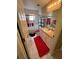 Bathroom has shower-tub combination with bright red bath mat and decor at 3449 Village Green Ct, St Cloud, FL 34772