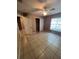 This bedroom is painted with neutral colors and features tile flooring, a ceiling fan, and closet at 3449 Village Green Ct, St Cloud, FL 34772