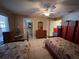 Spacious bedroom with twin beds, tile floors, and a view into the bathroom at 3449 Village Green Ct, St Cloud, FL 34772