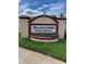 Entrance sign to Village Green Town Houses with landscaping in a well-maintained neighborhood at 3449 Village Green Ct, St Cloud, FL 34772