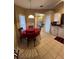 Functional dining area featuring tile flooring, pendant lighting, and a view of the home's interior at 3449 Village Green Ct, St Cloud, FL 34772