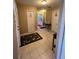 Hallway with tile flooring leading to bedrooms and bathrooms, enhanced by decorative touches at 3449 Village Green Ct, St Cloud, FL 34772