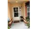 Charming front porch decorated with plants and seasonal décor, creating a welcoming entrance at 3449 Village Green Ct, St Cloud, FL 34772