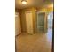 This hallway is bright and features tile flooring and multiple doorways at 3449 Village Green Ct, St Cloud, FL 34772