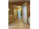 Hallway with tile flooring leading to the bathroom and kitchen, offering a seamless transition between spaces at 3449 Village Green Ct, St Cloud, FL 34772