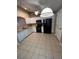 Well-lit kitchen boasting modern appliances, white cabinetry, and sleek countertops, perfect for culinary enthusiasts at 3449 Village Green Ct, St Cloud, FL 34772