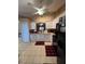 Bright kitchen with white cabinets, tile flooring, and modern appliances at 3449 Village Green Ct, St Cloud, FL 34772