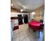 Kitchen and dining area with white cabinetry, black appliances, and tile flooring at 3449 Village Green Ct, St Cloud, FL 34772