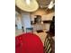 Kitchen and dining area with white cabinetry, black appliances, and tile flooring at 3449 Village Green Ct, St Cloud, FL 34772