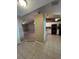 Open-concept kitchen features white cabinetry, modern appliances, and tile flooring that connects to the living area at 3449 Village Green Ct, St Cloud, FL 34772