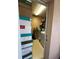 Functional laundry room featuring tile flooring, stacked boxes, and modern appliances; practical and efficient at 3449 Village Green Ct, St Cloud, FL 34772