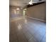 Large, inviting living room boasts expansive tile flooring and ample natural light, creating a welcoming atmosphere at 3449 Village Green Ct, St Cloud, FL 34772