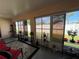Sunroom has multiple windows with a view of the backyard, neutral walls, and decor at 3449 Village Green Ct, St Cloud, FL 34772