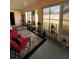 Bright sunroom with multiple windows, red sofa, and decor at 3449 Village Green Ct, St Cloud, FL 34772