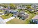 An aerial view of a home with a manicured lawn, in a quaint neighborhood at 410 Lark Ct, Kissimmee, FL 34759