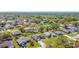 An aerial view showcases a charming neighborhood with lush trees and well-maintained homes at 410 Lark Ct, Kissimmee, FL 34759