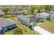 Aerial view of a single-story home, solar panels, and a well-manicured lawn in a suburban neighborhood at 410 Lark Ct, Kissimmee, FL 34759