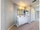 Bright bathroom featuring double vanity, tiled floors, and neutral paint at 410 Lark Ct, Kissimmee, FL 34759