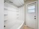 Bright bathroom with a white shower/tub combo and tiled floors at 410 Lark Ct, Kissimmee, FL 34759