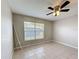 Bedroom featuring tile flooring, ceiling fan, and a window with natural light at 410 Lark Ct, Kissimmee, FL 34759