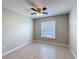 Bedroom featuring tile flooring, ceiling fan and a window with natural light at 410 Lark Ct, Kissimmee, FL 34759
