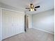 Bedroom featuring tile flooring, ceiling fan, and closet at 410 Lark Ct, Kissimmee, FL 34759