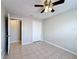 Bedroom featuring tile flooring, ceiling fan, and a closet at 410 Lark Ct, Kissimmee, FL 34759