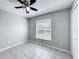 Bright bedroom with tile floors, a window, and ceiling fan at 410 Lark Ct, Kissimmee, FL 34759