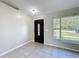 A bright foyer with neutral colors, a tiled floor and an exterior window at 410 Lark Ct, Kissimmee, FL 34759