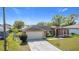 Inviting home with a spacious driveway and landscaping, perfect for curb appeal at 410 Lark Ct, Kissimmee, FL 34759