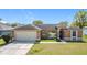 Well-kept home with a garage and front lawn, offering comfort and convenience at 410 Lark Ct, Kissimmee, FL 34759