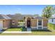 Traditional home with front yard and walkway leading to the front door at 410 Lark Ct, Kissimmee, FL 34759