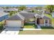Charming single-story home featuring a two-car garage and well-maintained front yard at 410 Lark Ct, Kissimmee, FL 34759