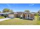 Exterior home showcasing its front facade, well-maintained lawn, and an attached two-car garage at 410 Lark Ct, Kissimmee, FL 34759