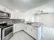 Modern kitchen with stainless steel appliances, granite countertops, and a tile backsplash at 410 Lark Ct, Kissimmee, FL 34759