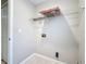 Laundry room featuring tiled floors, utility connections, and shelving at 410 Lark Ct, Kissimmee, FL 34759