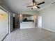 Open living area with tile flooring, ceiling fan, and access to the outdoor patio at 410 Lark Ct, Kissimmee, FL 34759