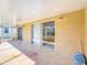 This covered patio includes sliding glass doors, overhead lighting, and ample space for outdoor seating at 410 Lark Ct, Kissimmee, FL 34759