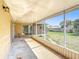 This screened-in patio offers a pleasant outdoor seating area with views of the backyard at 410 Lark Ct, Kissimmee, FL 34759