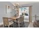 Bright dining area showcasing a modern chandelier, ample natural light, and seating at 413 Paloma Dr, Davenport, FL 33837