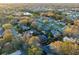Community aerial view showcases the homes, mature trees, and nearby lake at 4172 Stonehenge Rd, Mulberry, FL 33860