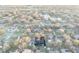 Wide aerial view shows the neighborhood layout with pond and treed streets at 4172 Stonehenge Rd, Mulberry, FL 33860