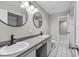 Bathroom featuring dual sinks, round mirrors, and tiled shower/bath at 4172 Stonehenge Rd, Mulberry, FL 33860