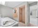 Bathroom featuring dual sinks, walk-in shower and bath at 4172 Stonehenge Rd, Mulberry, FL 33860
