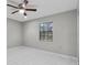 Bedroom featuring a ceiling fan, neutral walls and a bright window at 4172 Stonehenge Rd, Mulberry, FL 33860