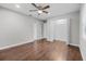 Bright bedroom features hardwood floors, ceiling fan, and ample closet space at 4172 Stonehenge Rd, Mulberry, FL 33860