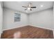 Cozy bedroom features hardwood floors, a ceiling fan, and a large window at 4172 Stonehenge Rd, Mulberry, FL 33860