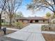 Charming brick home features a long driveway and mature trees in a quiet neighborhood at 4172 Stonehenge Rd, Mulberry, FL 33860