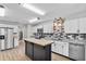 Beautiful updated kitchen with stainless steel appliances, white cabinets, and wood-look flooring at 4172 Stonehenge Rd, Mulberry, FL 33860